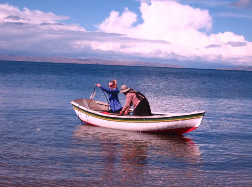 Melina helping her host mother prepare the boat on Lake Titicaca in their rural village stay.